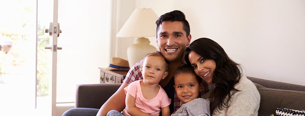 Happy family sitting on their new sofa